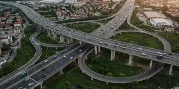 Modern highway interchange with multiple bridges under a clear sky, symbolizing infrastructure development.